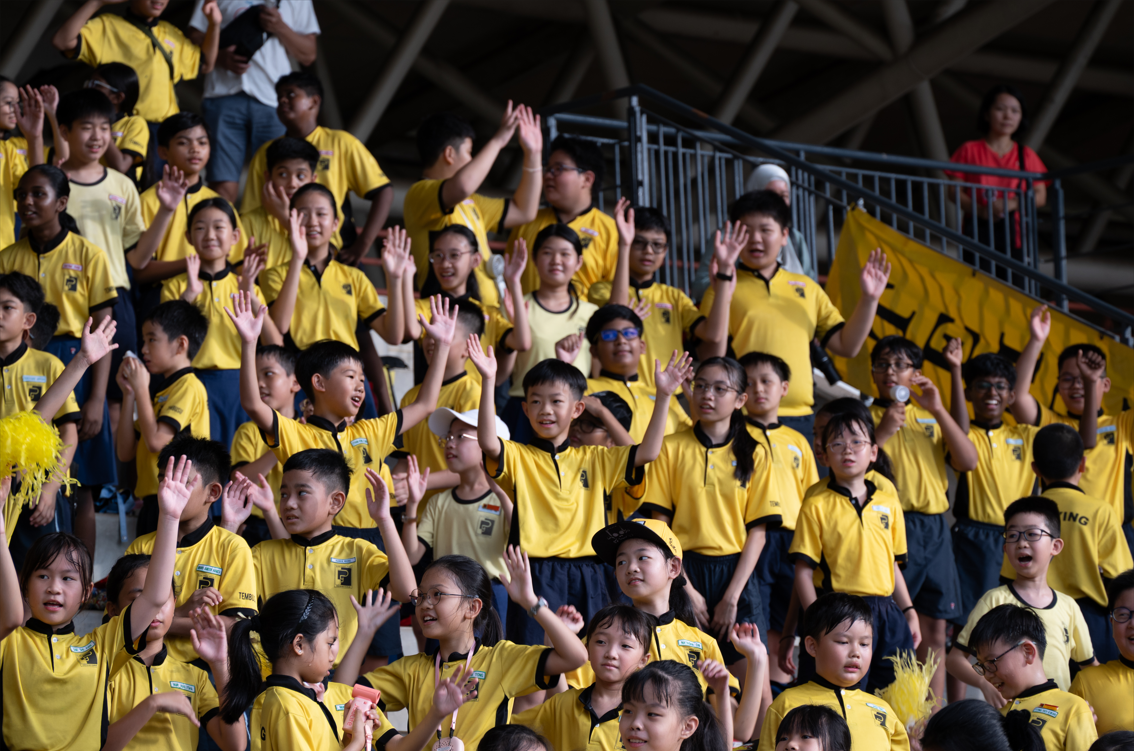 Students cheering from the spectator stands.